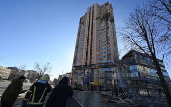 Firefighters extinguish fire in a high-rise apartment block which was hit by recent shelling in Kyiv on February 26, 2022. (Photo by GENYA SAVILOV / AFP) (Photo by GENYA SAVILOV/AFP via Getty Images)