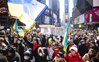 epaselect epa09787614 People gather in Times Square for a rally in support of the Ukrainian people and to protest Russia's invasion of the country this week in New York, New York, USA, 26 February 2022. Russian troops entered Ukraine on 24 February prompting the country's president to declare martial law and triggering a series of announcements by Western countries to impose severe economic sanctions on Russia.  EPA/JUSTIN LANE