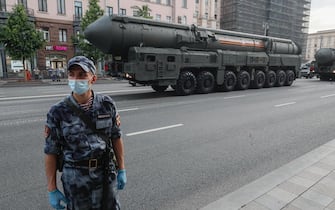 epa08491596 A Russian policeman wearing protective face mask guards in front of Russian strategic nuclear missiles RS-24 Yars which moves along a street prior to a night rehearsal of the Victory military parade in the Red Square, in Moscow, Russia, 17 June 2020. The military parade marking the 75th anniversary of the victory over Nazi Germany in the World War II will take place on the Red Square on 24 June 2020. The traditional troops parade as part of the Victory Day Parade which is annually held on 09 May, was cancelled due to Covid-19 epidemic in Russia.  EPA/SERGEI ILNITSKY