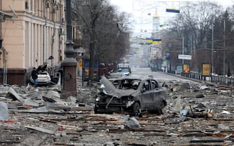 KHARKIV, UKRAINE - MARCH 1, 2022 - A burnt-out car is seen on the street after a missile launched by Russian invaders hit near the Kharkiv Regional State Administration building in Svobody (Freedom) Square) at approximately 8 am local time on Tuesday, March 1, Kharkiv, northeastern Ukraine.