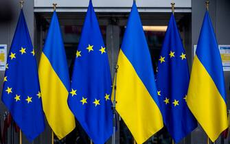 1375068179 BRUSSELS, BELGIUM - MARCH 01: Flags of the European Union and Ukraine are seen at the entrance of the European Parliament during a demonstration in front of the European Parliament on March 01, 2022 in Brussels, Belgium. Hundreds of people gathered in front of the European Parliament to show their support for the Ukrainian people, including dozens of Ukrainians living in Belgium. The President of the European Parliament, Roberta Metsola, accompanied by MEPs gave a speech to those present in which she made clear the European Union's support for Ukraine and welcomed Ukraine's application for EU membership. On February 24, 2022 Russia began a large-scale attack on Ukraine, with explosions reported in multiple cities and far outside the restive eastern regions held by Russian-backed rebels. (Photo by Omar Havana/Getty Images)
