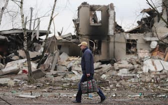 epa09799166 A man goes past burned buildings that were hit by shelling in the small city of Borodyanka near Kiev, Ukraine, 03 March 2022. Russian troops entered Ukraine on 24 February prompting the country's president to declare martial law.  EPA/ALISA YAKUBOVYCH
