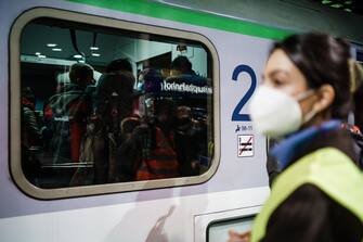 epa09797507 Passengers stand in an arriving train from Przemysl, carrying refugees of the Ukrainian-Polish border, at Berlin central station Hauptbahnhof in Berlin, Germany, 02 March 2022. Russian troops entered Ukraine on 24 February prompting the country's president to declare martial law and triggering a series of announcements by Western countries to impose severe economic sanctions on Russia. Refugees fleeing Ukraine are brought by trains, among other destinations, to the German capital.  EPA/CLEMENS BILAN