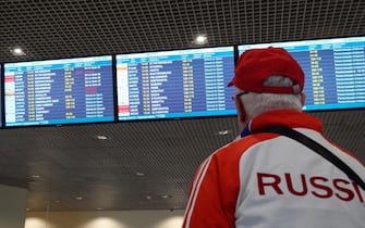 epa09242848 A man looks at the information board at airport Domodedovo in Moscow, Russia, 02 June 2021. German airline Lufthansa cancelled two flights from Frankfurt to Moscow and back bypass Belarus.  EPA/MAXIM SHIPENKOV