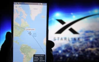 UKRAINE - 2020/10/28: A satellite tracker image is seen displayed on a smartphone with a Starlink logo in the background. (Photo Illustration by Pavlo Gonchar/SOPA Images/LightRocket via Getty Images)