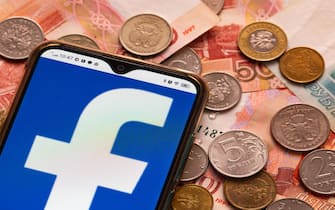 In this photo illustration, a Facebook logo is displayed on a smartphone with Russian money in the background.
Facebook has joined the sanctions against Russia. (Photo by Igor Golovniov / SOPA Images/Sipa USA)