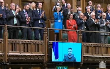 Ambassador of Ukraine to the UK, Vadym Prystaiko (left) and MPs give a standing ovation after Ukrainian President Volodymyr Zelensky addressed MPs in the House of Commons via videolink on the latest situation in Ukraine. Picture date: Tuesday March 8, 2022. (Photo by House of Commons/PA Images via Getty Images)