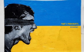 This photograph taken on March 4, 2022 shows a street art painting created by French street arist Kelu Abstract dedicated to the Ukrainian people after the Russian invasion of Ukraine, in Paris. - More than 1.2 million people have fled Ukraine into neighbouring countries since Russia launched its full-scale invasion on February 24, United Nations figures showed on March 4, 2022. - RESTRICTED TO EDITORIAL USE - MANDATORY MENTION OF THE ARTIST UPON PUBLICATION - TO ILLUSTRATE THE EVENT AS SPECIFIED IN THE CAPTION (Photo by Ludovic MARIN / AFP) / RESTRICTED TO EDITORIAL USE - MANDATORY MENTION OF THE ARTIST UPON PUBLICATION - TO ILLUSTRATE THE EVENT AS SPECIFIED IN THE CAPTION / RESTRICTED TO EDITORIAL USE - MANDATORY MENTION OF THE ARTIST UPON PUBLICATION - TO ILLUSTRATE THE EVENT AS SPECIFIED IN THE CAPTION (Photo by LUDOVIC MARIN/AFP via Getty Images)