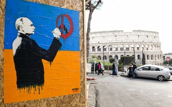 Street artist Harry Greb's new anti-war work entitled Vandal, near the Colosseum. It is a poster with the colors of the Ukrainian flag that portrays Russian President Vladimir Putin while he draws some missiles on the symbol of peace. Rome (Italy), February 28th, 2022 (Photo by Marilla Sicilia/Archivio Marilla Sicilia/Mondadori Portfolio via Getty Images)