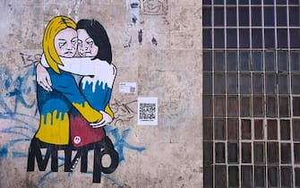 A mural by Italian street artist alias ÔLaikaÕ, depicting a hug between a Russian and a Ukrainian women against the war in Uklraine, is seen on the occasion of the International WomenÕs Day in Rome, Italy, 8 March 2022. ANSA/RICCARDO ANTIMIANI