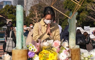 epa09816625 A woman offers a prayer on the 11th anniversary of Japan's 2011 earthquake and tsunami, in Tokyo, Japan, 11 March 2022. On 11 March 2011 a magnitude 9.0 earthquake triggered a tsunami, devastating northern Japan and Tokyo Electric Power Company's Fukushima Daiichi Nuclear Power Plant. According to the National Police Agency, 15,900 people died and 2,523 are still missing.  EPA/KIMIMASA MAYAMA