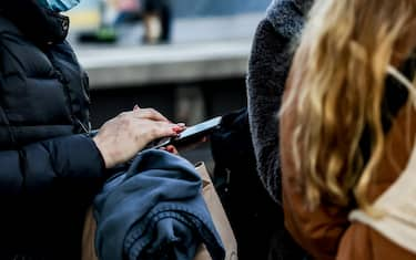 epa09791945 A refugee arriving from Ukraine checks her phone at the main train station in Berlin, Germany, 28 February 2022. Volunteers help Ukrainian refugees arriving by trains to find a way to refugees centres and provide food and water. Russian troops entered Ukraine on 24 February prompting the country's president to declare martial law and triggering a series of severe economic sanctions imposed by Western countries on Russia.  EPA/FILIP SINGER