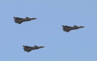 Chinese J-20 stealth fighter jets fly past during a military parade at the Zhurihe training base in China's northern Inner Mongolia region on July 30, 2017.
China held a parade of its armed forces on July 30 to mark the 90th anniversary of the People's Liberation Army (PLA) in a display of military might. / AFP PHOTO / STR / China OUT        (Photo credit should read STR/AFP via Getty Images)