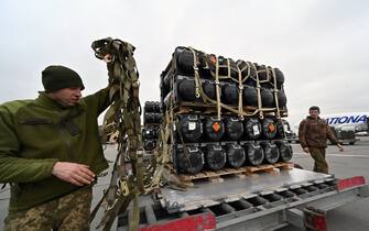 Ukrainian servicemen unload a Boeing 747-412 plane with the FGM-148 Javelin, American man-portable anti-tank missile provided by US to Ukraine as part of a military support, at Kyiv's airport Boryspil on February 11,2022, amid the crisis linked with the threat of Russia's invasion. (Photo by Sergei SUPINSKY / AFP) (Photo by SERGEI SUPINSKY/AFP via Getty Images)