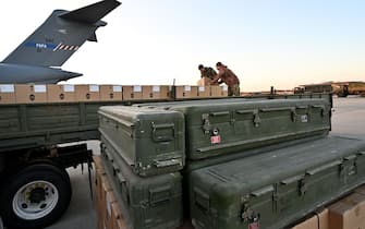 Servicemen of Ukrainian Military Forces load a flat bed truck with boxes as US made FIM-92 Stinger missiles (Front), a man-portable air-defence system (MANPADS), that operates as an infrared homing surface-to-air missile (SAM), are stacked after being shipped in to Boryspil Airport in Kyiv on February 13, 2022. (Photo by Sergei SUPINSKY / AFP) (Photo by SERGEI SUPINSKY/AFP via Getty Images)