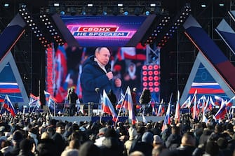 epa09833704 A screen shows Russian President Vladimir Putin delivering a speech during a concert marking the 8th anniversary of Crimea's reunification with Russia at the Luzhniki stadium in Moscow, Russia, 18 March 2022. Russia in 2014 annexed the Black Sea peninsula, shortly after Crimeans voted in a disputed referendum to secede from Ukraine.  EPA / VLADIMIR ASTAPKOVICH / SPUTNIK / POOL MANDATORY CREDIT