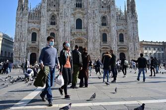 People wearing protective masks walk across the Piazza del Duomo in Milan on October 17, 2020, amid the Covid-19 pandemic. - Italy's government has made it mandatory to wear face protection outdoors, in an attempt to counter the spread of the coronavirus Covid-19 pandemic. (Photo by MIGUEL MEDINA / AFP) (Photo by MIGUEL MEDINA/AFP via Getty Images)
