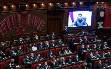 epa09841988 Members of the Italian Parliament make a standing ovation at Ukraine's President Volodymyr Zelensky (on screen), at the end of his speech to members of the Italian Parliament via video conference during an extraordinary Plenary session debating on the 'Russian aggression against Ukraine', at the Italian Parliament in Rome, Italy, 22 March 2022. On 24 February Russian troops had entered Ukrainian territory in what the Russian president declared a 'special military operation', resulting in fighting and destruction in the country, a huge flow of refugees, and multiple sanctions against Russia.  EPA/ROBERTO MONALDO / POOL