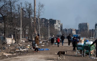 Residents seen on the street after emerging from bomb shelters, civilians gather their belongings and supplies as they prepare to flee the embattled city of Mariupol following intense bombardment. Intense bombardment has seen much of the strategic coastal town reduced to ruins as Ukrainian forces under the controversial Azov battalion attempt to defend the town against mounting pressure from the Russian / pro-Russian forces.