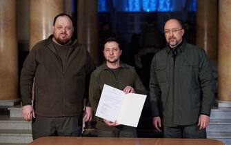 1238833700 KYIV, UKRAINE - FEBRUARY 28: (----EDITORIAL USE ONLY â MANDATORY CREDIT - "UKRAINIAN PRESIDENCY/ HANDOUT" - NO MARKETING NO ADVERTISING CAMPAIGNS - DISTRIBUTED AS A SERVICE TO CLIENTS----) Ukrainian President Volodymyr Zelenskyy (C) signs the country's application for membership in the European Union in Kyiv, Ukraine on February 28, 2022. (Photo by UKRAINIAN PRESIDENCY/Anadolu Agency via Getty Images)