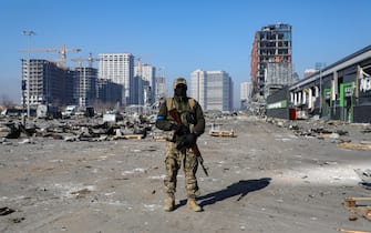 KYIV, UKRAINE - MARCH 23, 2022 - A soldier is pictured outside a shopping mall ruined as a result of a missile strike carried out by the Russian troops in the Podilskyi district of Kyiv, capital of Ukraine.
