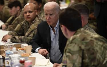 US President Joe Biden (C) talks to service members from the 82nd Airborne Division, who are contributing alongside Polish Allies to deterrence on the Alliances Eastern Flank, in the city of Rzeszow in southeastern Poland, around 100 kilometres (62 miles) from the border with Ukraine, on March 25, 2022. - Biden is due to meet US soldiers stationed in the area and non-governmental organisations helping Ukrainian refugees fleeing Russia's invasion. (Photo by Brendan SMIALOWSKI / AFP) (Photo by BRENDAN SMIALOWSKI/AFP via Getty Images)
