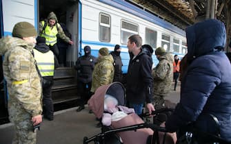 Lviv, Ukraine - March 11, 2022 - A woman with a baby in a pram stands on the platform as people fleeing the Russian invasion await an evacuation train to Przemysl, Poland, at the main railway station in Lviv, western Ukraine.  Photo by Alona Nikolaievych / Ukrinform / ABACAPRESS.COM