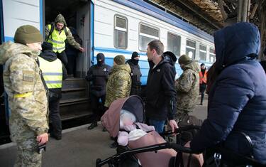 Lviv, Ukraine - March 11, 2022 - A woman with a baby in a pram stands on the platform as people fleeing the Russian invasion await an evacuation train to Przemysl, Poland, at the main railway station in Lviv, western Ukraine. Photo by Alona Nikolaievych/Ukrinform/ABACAPRESS.COM