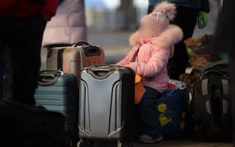 Lviv, Ukraine - March 11, 2022 - A little girl sits by suitcases as people fleeing the Russian invasion await an evacuation train to Przemysl, Poland, at the main railway station in Lviv, western Ukraine. Photo by Alona Nikolaievych/Ukrinform/ABACAPRESS.COM