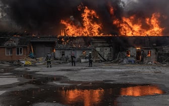 epa09856061 Firefighters extinguish the fire in a warehouse that was hit by the Russian artillery shelling, in Kharkiv, northeast Ukraine, 28 March 2022. Kharkiv, Ukraine s second-largest city of 1.5 million people, which lies about 25 miles from the Russian border, has been heavily shelled by Russian forces over the past weeks, with many civilians killed in the city.  EPA/ROMAN PILIPEY