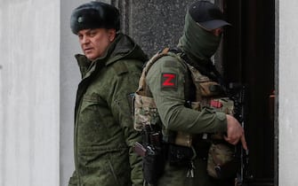 epaselect epa09853341 The head of self-proclaimed Luhansk People's Republic (LPR) Leonid Pasechnik (L) leaves Luhansk region administration building in Luhansk, Ukraine, 27 March 2022. A referendum on the entry of the Luhansk People's Republic (LPR) into Russia may be held in the near future, said the head of self-proclaimed LPR Leonid Pasechnik. On 24 February Russian troops had entered Ukrainian territory in what the Russian president declared a 'special military operation', resulting in fighting and destruction in the country, a huge flow of refugees, and multiple sanctions against Russia.  EPA/SERGEI ILNITSKY