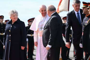 Malta's President, George Vella (C-R) and his wife Miriam Vella (L) greet Pope Francis (C) after he landed on April 02, 2022 at Malta's international airport in Luqa, for a two-day trip to the island. - Pope Francis heads for a two-day trip to Catholic-majority Malta where he will again highlight the plight of migrants, as the Ukraine war sends a stream of refugees across Europe. (Photo by Andreas SOLARO / AFP) (Photo by ANDREAS SOLARO/AFP via Getty Images)
