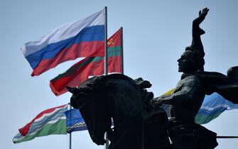 State flags of Russia and Transnistria fly in the wind close to the monument to the 18th century Russian military commander Alexander Suvorov in the town of Tiraspol, the capital of Transnistria - Moldova's pro-Russian breakaway region on the eastern border with Ukraine, on September 12, 2021. (Photo by Sergei GAPON / AFP) (Photo by SERGEI GAPON/AFP via Getty Images)