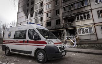 An ambulance drives past a burnt building in the eastern Ukraine city of Kharkiv, on April 2, 2022, as Ukraine said today Russian forces were making a "rapid retreat" from northern areas around the capital Kyiv and the city of Chernigiv. (Photo by FADEL SENNA / AFP) (Photo by FADEL SENNA/AFP via Getty Images)