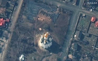 epa09869750 A handout satellite image made available by Maxar Technologies shows a probable grave site (C, top) near the Church of Saint Andrew and Pyervozvannoho All Saints in Bucha, Ukraine, 31 March 2022 (issued 04 April 2022).  EPA/MAXAR TECHNOLOGIES HANDOUT -- MANDATORY CREDIT: SATELLITE IMAGE 2022 MAXAR TECHNOLOGIES -- THE WATERMARK MAY NOT BE REMOVED/CROPPED -- HANDOUT EDITORIAL USE ONLY/NO SALES