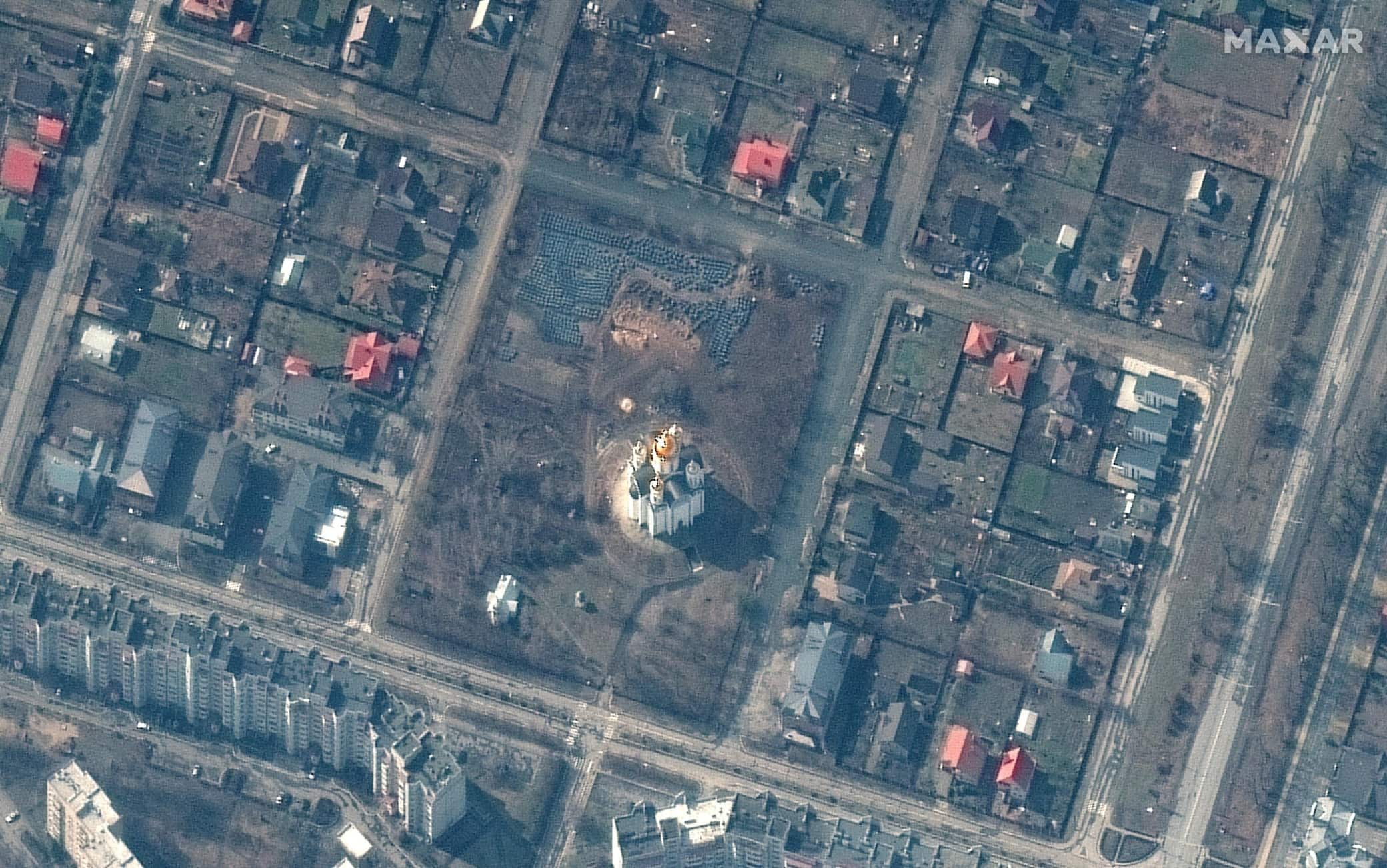 epa09869749 A handout satellite image made available by Maxar Technologies shows a probable grave site (C-top) near the Church of Saint Andrew and Pyervozvannoho All Saints in Bucha, Ukraine, 31 March 2022 (issued 04 April 2022).  EPA/MAXAR TECHNOLOGIES HANDOUT -- MANDATORY CREDIT: SATELLITE IMAGE 2022 MAXAR TECHNOLOGIES -- THE WATERMARK MAY NOT BE REMOVED/CROPPED -- HANDOUT EDITORIAL USE ONLY/NO SALES