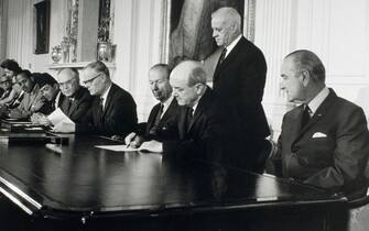President Johnson looks on as Secretary of State Dean Rusk signs the treaty for the Non-Proliferation of Nuclear Weapons. (Photo by © CORBIS/Corbis via Getty Images)