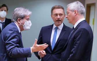 BRUSSELS, BELGIUM - MARCH 15: EU Commissioner for Economy Paolo Gentiloni (L) is talking with the German Federal Minister of Finance Christian Lindner (C) and the French Minister of the Economy Bruno Le Maire (R) prior an EU Ecofin Ministers meeting in the Europa, the European Union Council headquarter on March 15, 2022, in Brussels, Belgium. Over breakfast, economy and finance ministers will discuss the economic and financial consequences of the sanctions imposed on Russia after its military aggression against Ukraine. (Photo by Thierry Monasse/Getty Images)