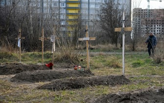 Graves with bodies of civilians next to apartments blocks in the recaptured by the Ukrainian army Bucha city near Kyiv, Ukraine, 04 April 2022. (Photo by Maxym Marusenko/NurPhoto via Getty Images)