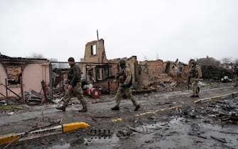 epa09868089 Ukrainian soldiers inspect destroyed Russian military machinery in the areas recaptured by the Ukrainian army in the city of Bucha, Ukraine, 03 April 2022. Dmitrivka and the area around had recently been recaptured by the Ukrainian army from Russian forces. On 24 February, Russian troops had entered Ukrainian territory in what the Russian president declared a 'special military operation', resulting in fighting and destruction in the country, a huge flow of refugees, and multiple sanctions against Russia  EPA/ATEF SAFADI