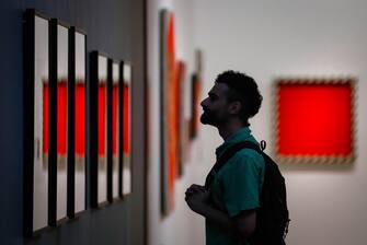 epa08530782 A visitor looks at paintings during the exhibition preview 'Not Forever. 1968-1985' at the State Tretyakov Gallery in Moscow, Russia, 06 July 2020. The exhibition runs from 07 July to 11 October 2020.  EPA/YURI KOCHETKOV