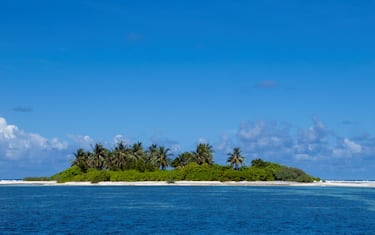 Asia's smallest and least-known nation, the Republic of Maldives, lies scattered from north to south across a 750-kilometre sweep of the Indian Ocean 500 kilometres south-west of Sri Lanka. More than 1000 islands, together with innumerable banks and reefs, are grouped in a chain of nineteen atolls which extends from a point due west of Colombo to just south of the equator.<br/><br/>

The atolls, formed of great rings of coral based on the submarine Laccadive-Chagos ridge, vary greatly in size. Some are only a few kilometres square, but in the far south the great atoll of Suvadiva is sixty-five kilometres across, and has a central lagoon of more than 2000 square kilometres. The northern and central atolls are separated from each other by comparatively narrow channels of deep water, but in the south Suvadiva is cut off by the eighty-kilometre-wide One-and-a-half-Degree Channel. Addu Atoll is still more isolated, being separated from the atoll of Suvadiva by the seventy-kilometre-wide Equatorial Channel.