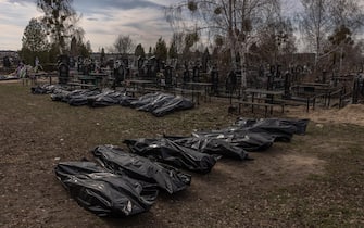epa09877012 Bodies of killed people, which were brought to the cemetery, lay on the ground in body bags, in Bucha, northwest of Kyiv, Ukraine, 07 April 2022. Hundreds of tortured and killed civilians have been found in Bucha and other parts of the Kyiv region after the Russian army retreated from those areas. The growing evidence shows that the Russian forces are believed to be behind the atrocities when they were controlling the areas. Russian troops entered Ukraine on 24 February resulting in fighting and destruction in the country and triggering a series of severe economic sanctions on Russia by Western countries.  EPA/ROMAN PILIPEY