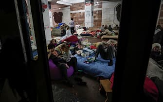 epa09878449 People take shelter in an underground metro station in Kharkiv, Ukraine, 08 April 2022, amid the ongoing Russian invasion of the country.  EPA/ATEF SAFADI
