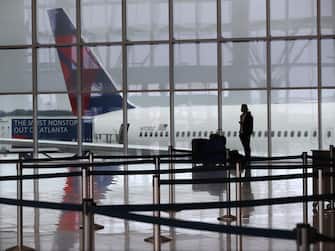 A Delta plane sits at the International Terminal at Hartsfield Jackson International Airport with a solitary traveler waiting for a flight amid new European travel restrictions on Monday, March 16, 2020, in Atlanta, GA, USA. International and domestic air travel have been hammered by the coronavirus. Photo by Curtis Compton/Atlanta Journal-Constitution/TNS/ABACAPRESS.COM