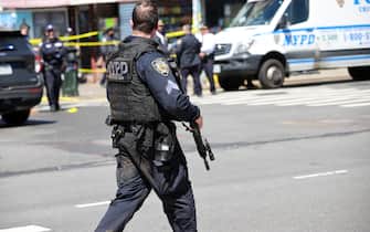 NEW YORK, USA - APRIL 12: New York City Police Department members investigate the crime scene after multiple people were shot and undetonated devices were found at a subway station in New York City, United States on April 12, 2022. Authorities said an investigation is underway and told residents to avoid the area of 36th Street and 4th Avenue in Brooklyn. (Photo by Tayfun Coskun/Anadolu Agency via Getty Images)