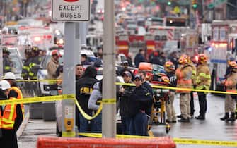 epa09885984 New York City Police and Fire Department officials on the scene of a reported multiple shooting at a New York City Subway station in the Brooklyn borough of New York, New York, USA, 12 April 2022.  EPA/JUSTIN LANE