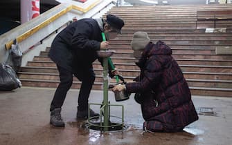 epa09809258 Ukrainians fill water at shelter in a metro station during shelling in Eastern Ukrainian city of Kharkiv, Ukraine, 06 March 2022 (made available on 08 March 2022). Russian troops entered Ukraine on 24 February prompting the country's president to declare martial law and triggering a series of announcements by Western countries to impose severe economic sanctions on Russia.  EPA/STANISLAV KOZLIUK