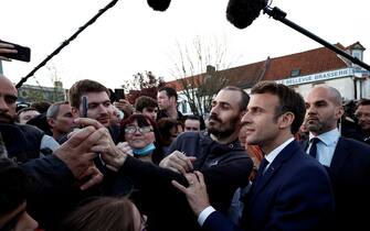 epa09884958 French President and a candidate for re-election Emmanuel Macron (R), meets with supporters during his first campaign day trip after coming first in the first round of the 2022 French presidential election, in Carvin, France, 11 April 2022.  EPA/BENOIT TESSIER / POOL  MAXPPP OUT