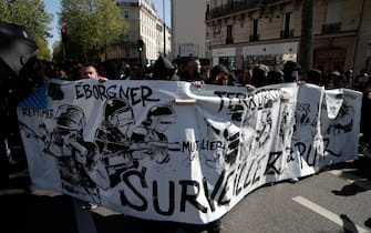 Protestors march behind a banner during a demonstration 'against racism and fascism' in Paris on April 16, 2022. (Photo by GEOFFROY VAN DER HASSELT / AFP) (Photo by GEOFFROY VAN DER HASSELT/AFP via Getty Images)